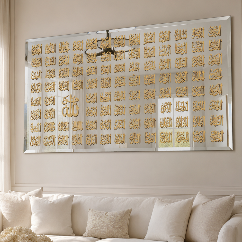 A large rectangular wall art piece with rows of gold Arabic calligraphy on a silver background, displayed above a white sofa in a bright, modern living room.