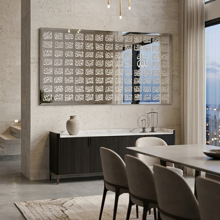 A modern dining room interior with a rectangular wall mirror featuring a black and white geometric pattern, mounted above a dark sideboard. The room has textured concrete walls, a light wood dining table, gray upholstered chairs, a hanging gold pendant light, and a large window with sheer curtains.
