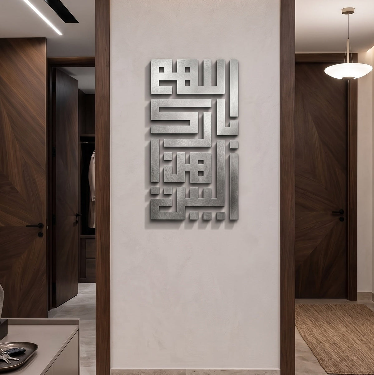 A modern interior hallway with a large metallic Arabic calligraphy wall art piece mounted on a light beige wall, flanked by dark wood trim and doors.