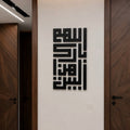 Black Arabic calligraphy wall art mounted on a white wall in a modern hallway with dark wood doors.