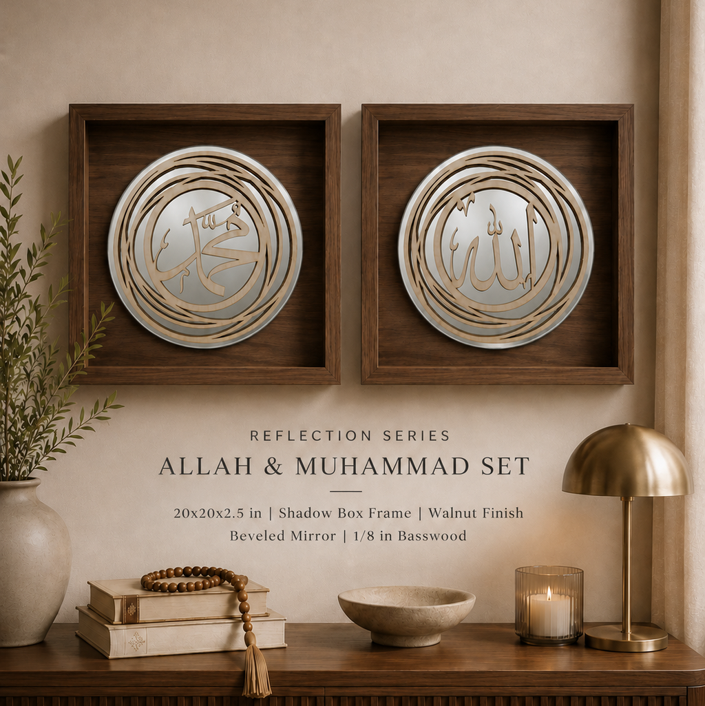 Two framed Islamic wall art pieces with reflective circular mirrors and gold Arabic calligraphy, displayed on a beige wall above a wooden console with books, a bowl, a candle, and a brass lamp. Text below reads 'Reflection Series Allah & Muhammad Set'.
